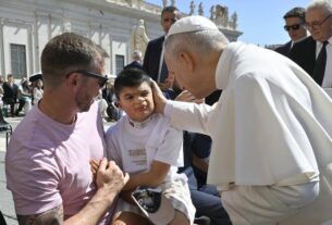 Pope Leo blesses a child at his July 30, 2025, general audience.